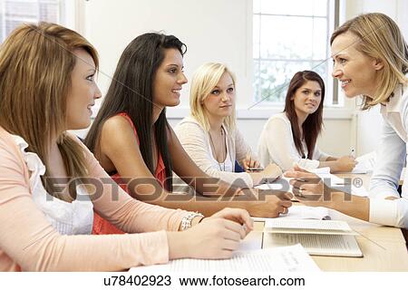 Stock Image - Students and tutor in class. Fotosearch