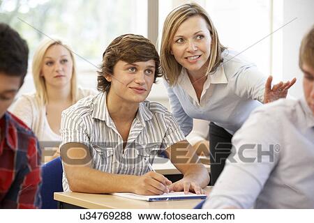 Stock Photo - Students and tutor in class. Fotosearch