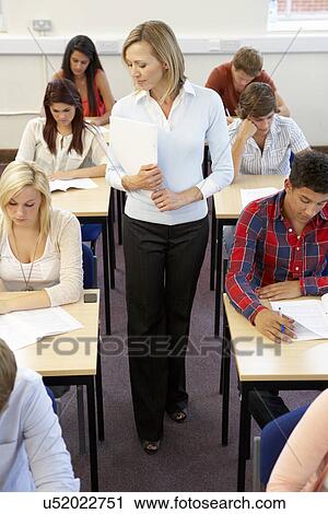 Students and tutor in exam View Large Photo Image Stock Image - Students and tutor in exam. Fotosearch