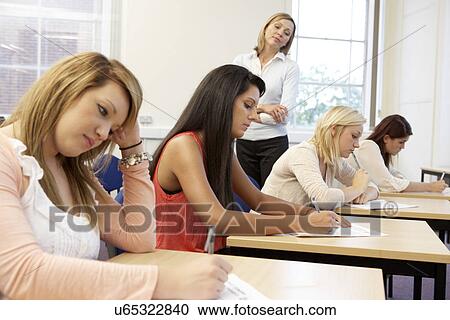 Students and tutor in exam View Large Photo Image Stock Image - Students and tutor in exam. Fotosearch