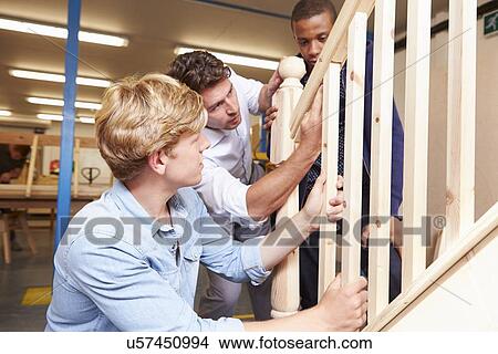 Picture - Students In Carpentry Class Working On Staircase. Fotosearch