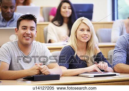 Stock Photography - Students Using Laptops And Digital Tablets In Lecture. Fotosearch