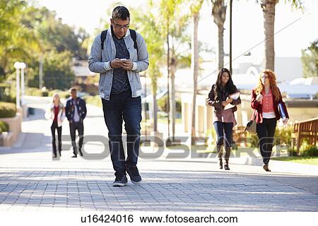Stock Photograph - Students Walking Outdoors On University Campus. Fotosearch