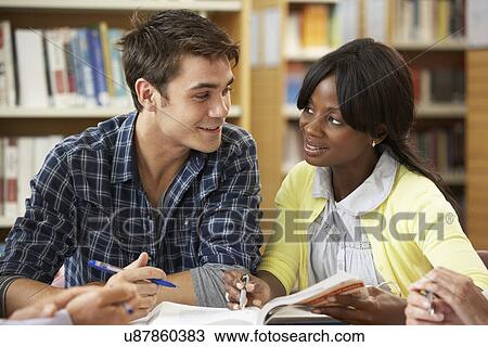 Stock Image - Students working in library. Fotosearch