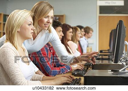 Stock Image - Students working on computers in library. Fotosearch