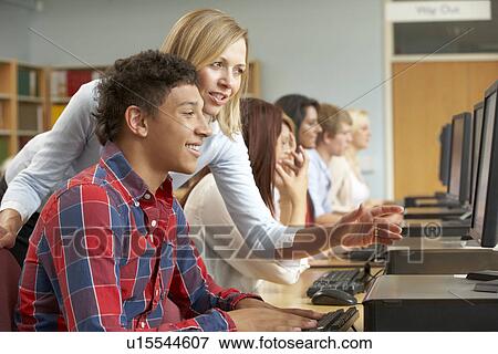 Students working on computers in library View Large Photo Image Stock Photo - Students working on computers in library. Fotosearch