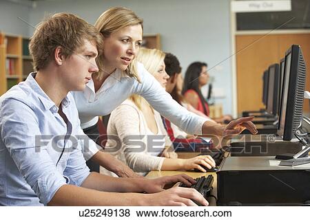 Students working on computers in library View Large Photo Image Stock Photo - Students working on computers in library. Fotosearch