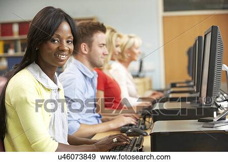 Students working on computers in library View Large Photo Image Stock Photo - Students working on computers in library. Fotosearch