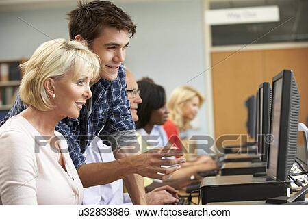 Stock Photograph - Students working on computers in library. Fotosearch