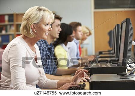 Stock Photography - Students working on computers in library. Fotosearch
