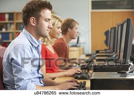 Stock Photography - Students working on computers in library. Fotosearch