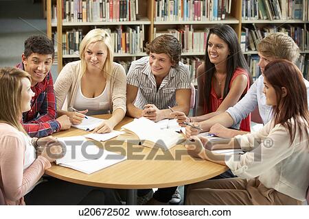 Stock Image - Students working together in library. Fotosearch