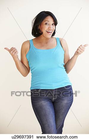 Stock Image - Studio Portrait Of Smiling Overweight Woman . Fotosearch