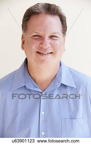 Stock Image - Studio Portrait Of Smiling Overweight Man . Fotosearch