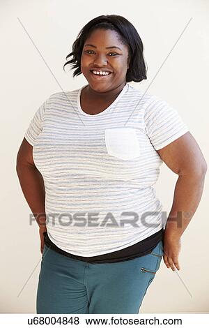 Stock Photo - Studio Portrait Of Smiling Overweight Woman . Fotosearch