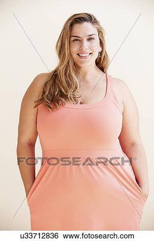 Studio Portrait Of Smiling Overweight Woman View Large Photo Image Stock Photograph - Studio Portrait Of Smiling Overweight Woman . Fotosearch