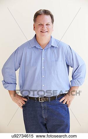 Stock Photography - Studio Portrait Of Smiling Overweight Man . Fotosearch