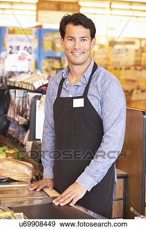 Stock Photo - Supermarket checkout worker. Fotosearch