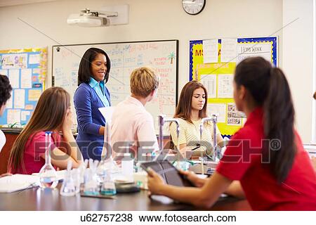 Stock Photo - Teacher And Pupils In High School Science Class. Fotosearch