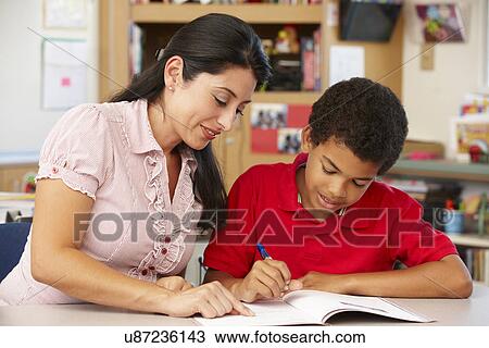 Teacher and schoolboy in class View Large Photo Image Stock Image - Teacher and schoolboy in class. Fotosearch