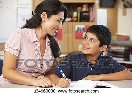 Stock Photo - Teacher and schoolboy in class. Fotosearch