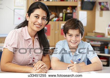 Stock Photography - Teacher and schoolboy in class. Fotosearch