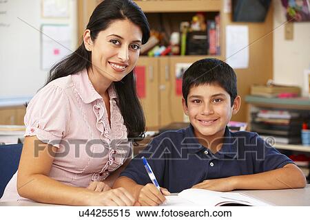 Stock Photography - Teacher and schoolboy in class. Fotosearch
