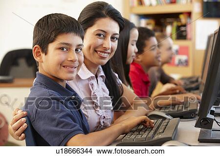 Picture - Teacher and schoolchildren in class. Fotosearch