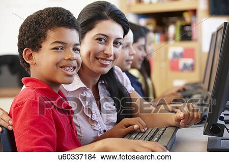 Picture - Teacher and schoolchildren in class. Fotosearch