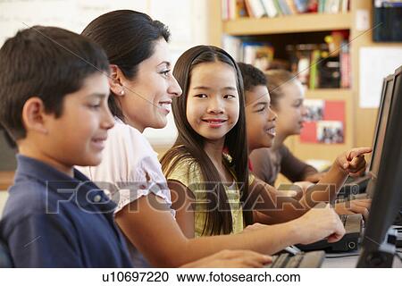 Stock Image - Teacher and schoolchildren in class. Fotosearch