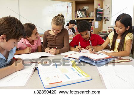 Stock Image - Teacher and schoolchildren in class. Fotosearch