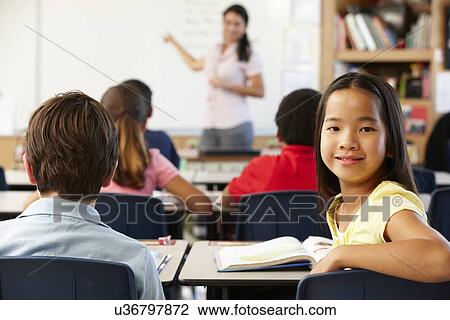 Stock Image - Teacher and schoolchildren in class. Fotosearch
