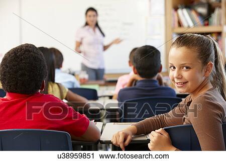 Stock Image - Teacher and schoolchildren in class. Fotosearch