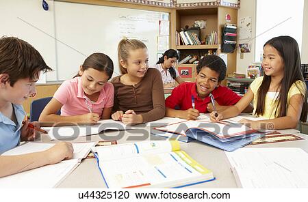 Stock Image - Teacher and schoolchildren in class. Fotosearch