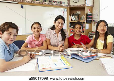 Stock Photo - Teacher and schoolchildren in class. Fotosearch