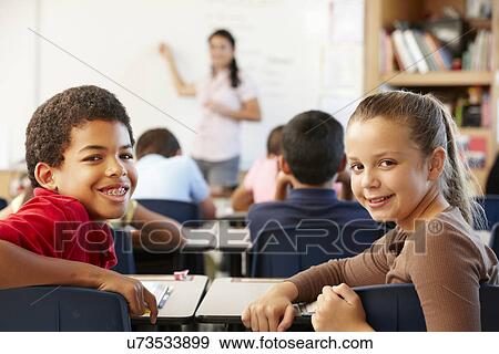 Stock Photo - Teacher and schoolchildren in class. Fotosearch