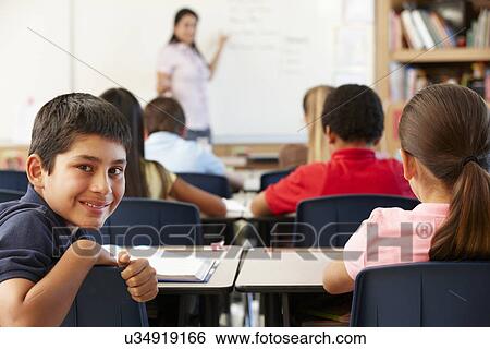 Teacher and schoolchildren in class View Large Photo Image Stock Photograph - Teacher and schoolchildren in class. Fotosearch