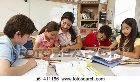 Stock Photograph - Teacher and schoolchildren in class. Fotosearch