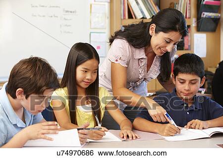 Teacher and schoolchildren in class View Large Photo Image Stock Photograph - Teacher and schoolchildren in class. Fotosearch