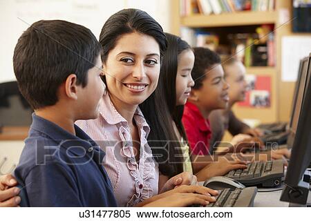 Stock Photography - Teacher and schoolchildren in class. Fotosearch