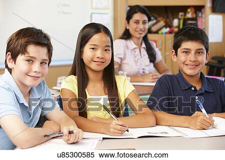 Stock Photography - Teacher and schoolchildren in class. Fotosearch
