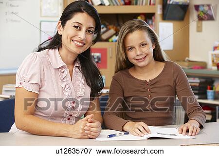 Teacher and schoolgirl in class View Large Photo Image Stock Photo - Teacher and schoolgirl in class. Fotosearch
