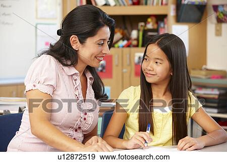 Stock Photo - Teacher and schoolgirl in class. Fotosearch