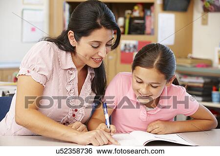 Teacher and schoolgirl in class View Large Photo Image Stock Photograph - Teacher and schoolgirl in class. Fotosearch