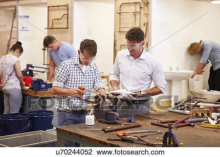 Teacher Helping College Students Studying Plumbing View Large Photo Image Stock Image - Teacher Helping College Students Studying Plumbing. Fotosearch