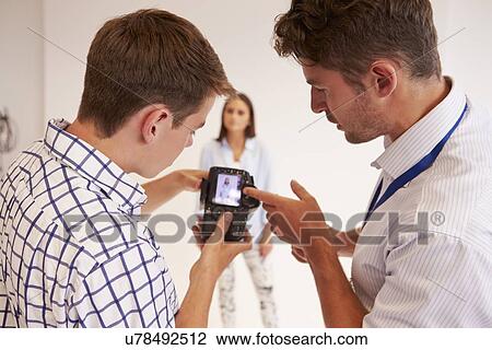 Teacher Helping College Students Studying Photography View Large Photo Image Stock Image - Teacher Helping College Students Studying Photography. Fotosearch