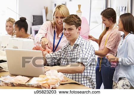 Teacher Helping College Students Studying Fashion And Design View Large Photo Image Stock Image - Teacher Helping College Students Studying Fashion And Design. Fotosearch