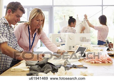 Teacher Helping College Students Studying Fashion And Design View Large Photo Image Stock Photo - Teacher Helping College Students Studying Fashion And Design. Fotosearch