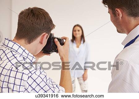 Stock Photograph - Teacher Helping College Students Studying Photography. Fotosearch