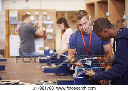 Teacher Helping Students Training To Be Electricians View Large Photo Image Stock Photo - Teacher Helping Students Training To Be Electricians. Fotosearch